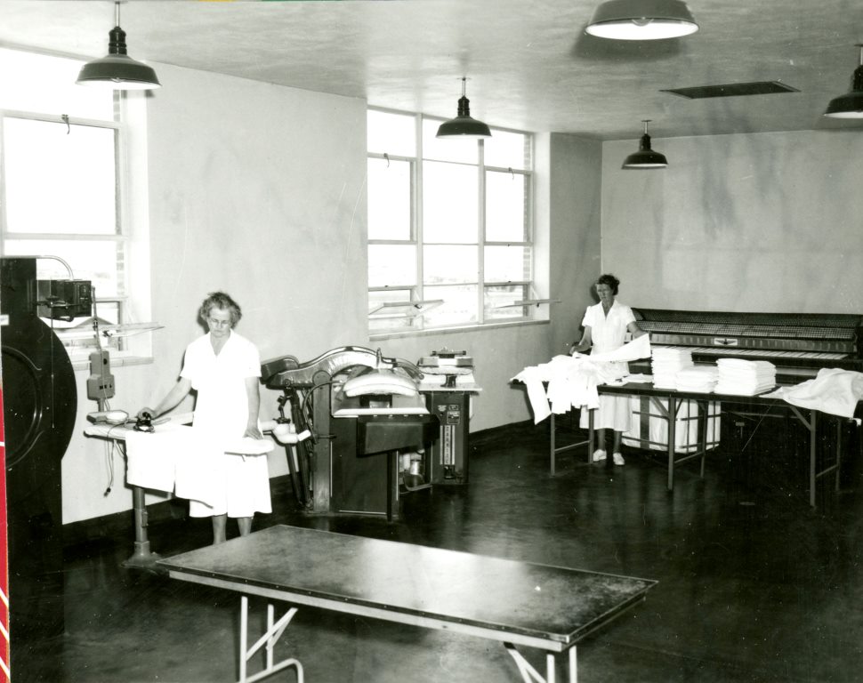 Two women working in the laundry at the Dixie Pioneer Memorial Hospital