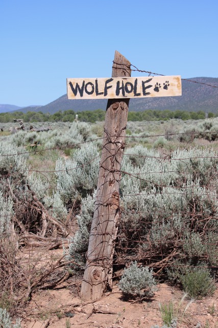 Wolf Hole sign on a fencepost