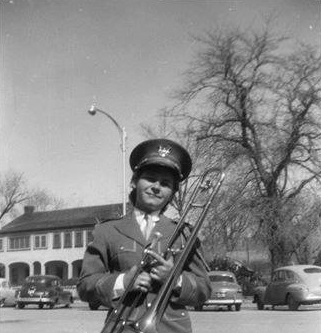 A Woodward Junior High School band member in front of the Orson Pratt home in 1955